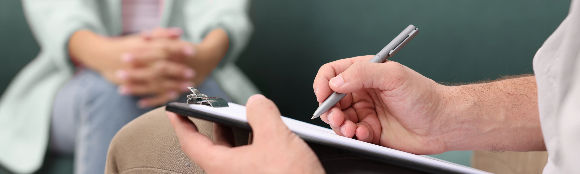 Man writing on clipboard